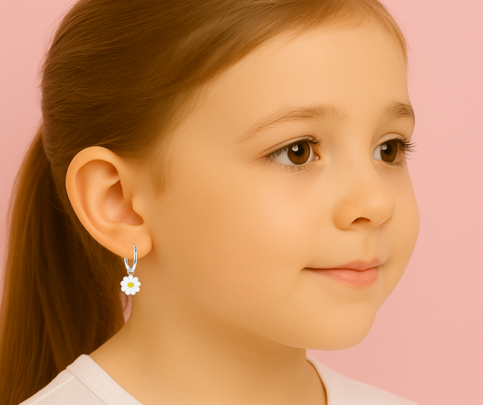 Daisy hoop earrings on a young girl, featuring 925 sterling silver with white and yellow enamel flower charms.