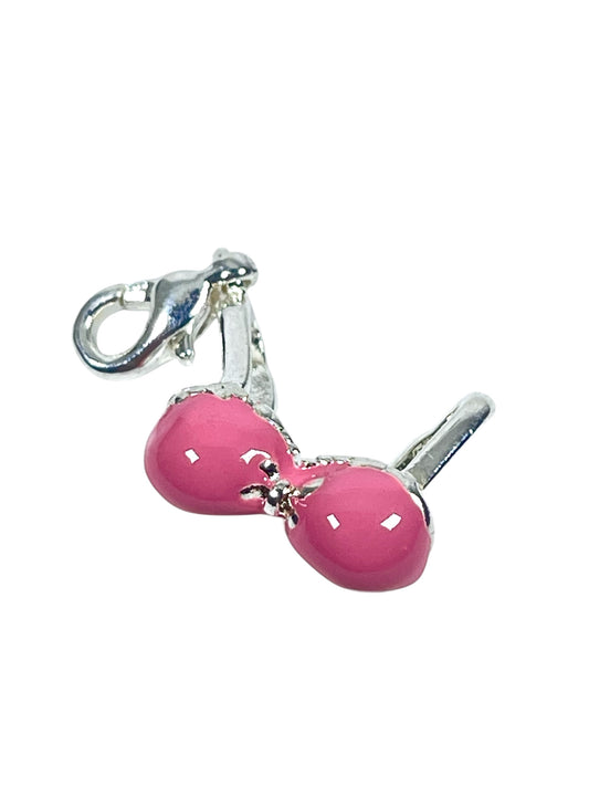 A silver-plated, pink enamelled bikini top charm with a clip for jewelry making.