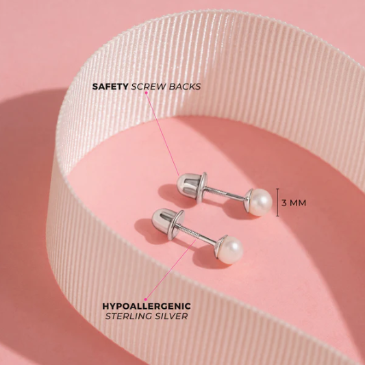 Pearl earrings with safety screw backs on a pink background