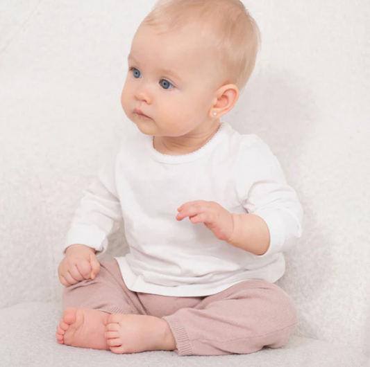 Adorable baby wearing baby pearl earrings, 3mm sterling silver safety screw backs, sitting in a cozy outfit.