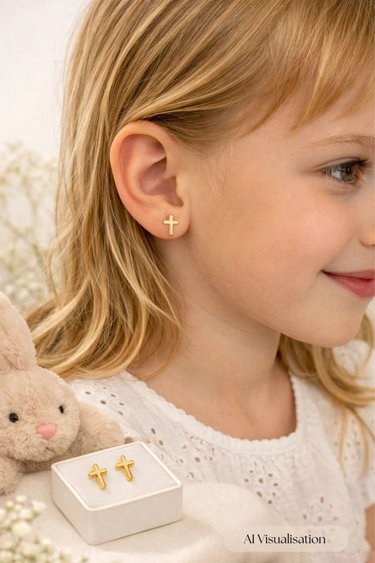 Children's earrings – child's profile wearing solid 14k yellow gold cross screw back stud earrings.