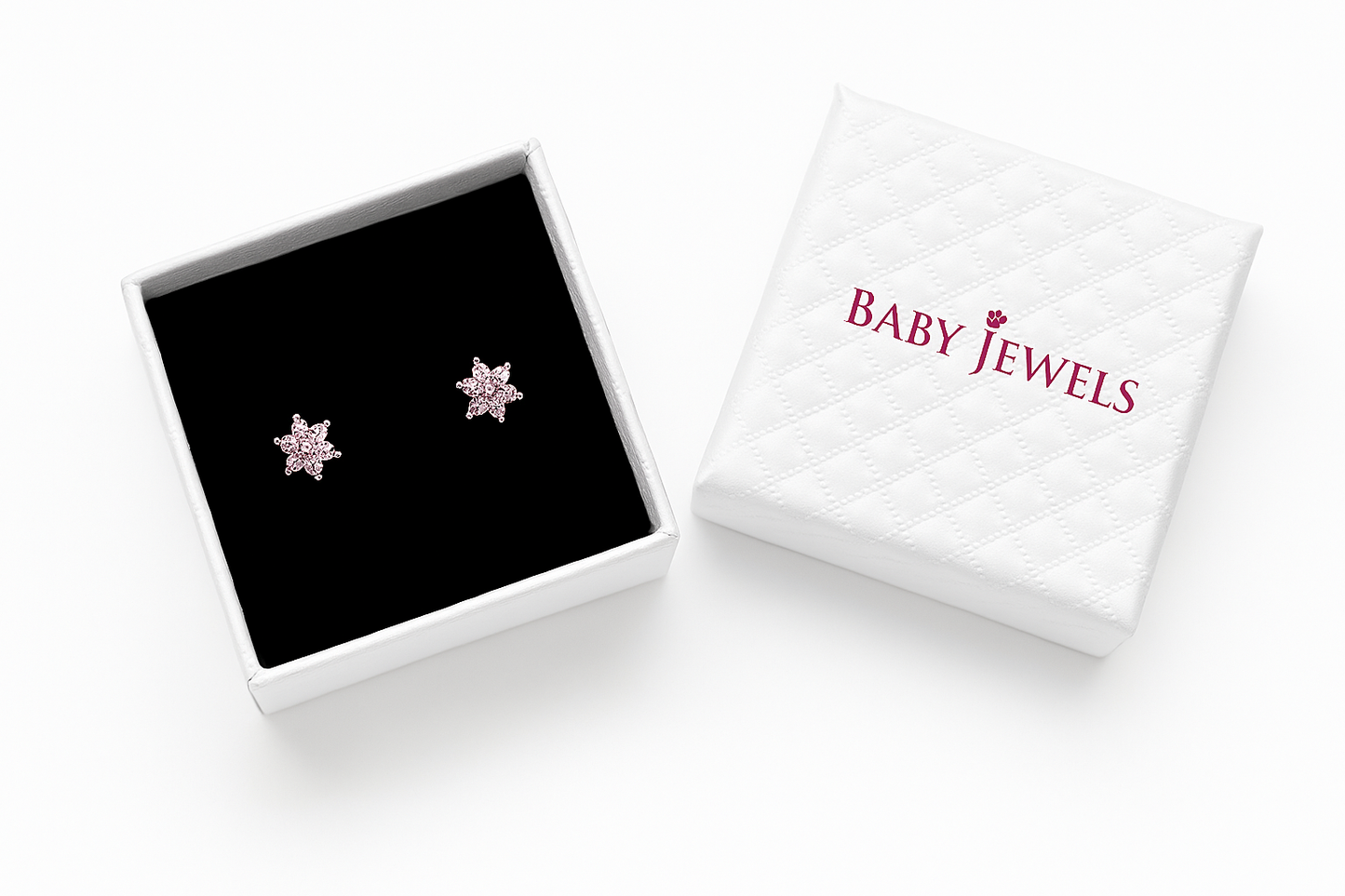 Star-shaped earrings in a 'Baby Jewels' box on a white background