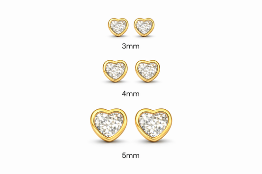 Children's earrings – Heart shaped cubic zirconia studs in 3mm, 4mm, and 5mm sizes with yellow gold bezel settings.