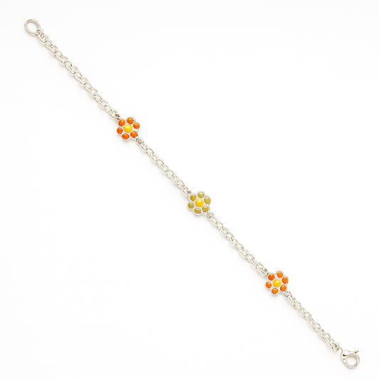 Diagonal product shot of a sterling-silver chain bracelet on a pure white background, featuring three enamel daisy charms—two with bright orange petals and one with pale green petals—spaced evenly along the chain, finished with an oval-link extension and lobster-clasp closure