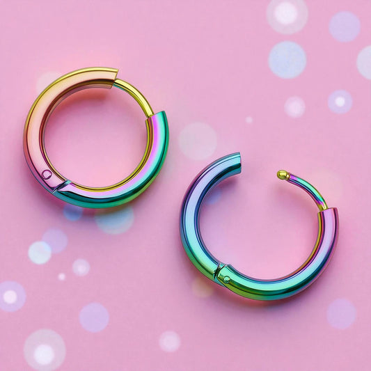 Children's earrings featuring anodised 316L surgical steel rainbow hoop design on a pink background.