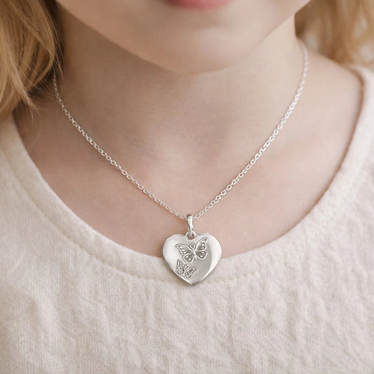 Children's necklaces featuring a sterling silver butterfly heart pendant worn by a child.