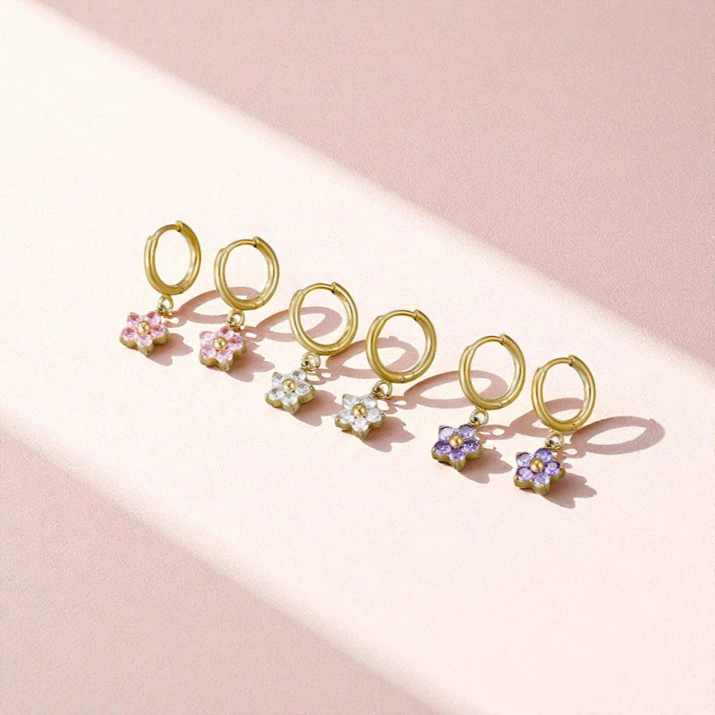 Flower hoop earrings showcasing purple, pink, and white cubic zirconia flowers on 18k gold plated surgical steel.