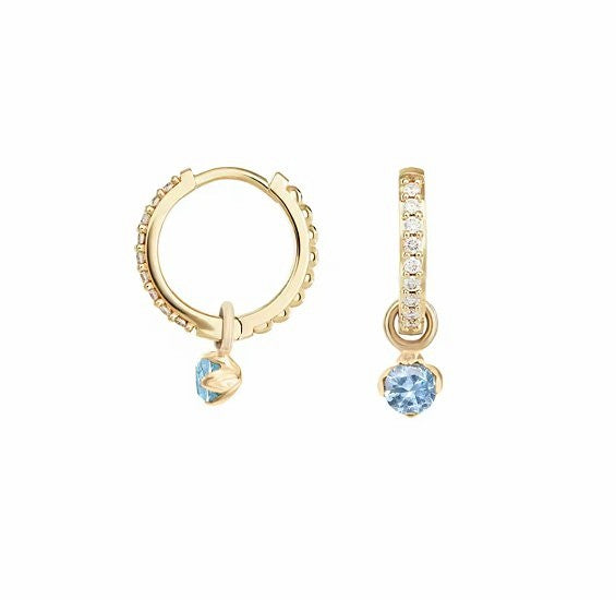 A pair of children's earrings featuring 18k gold over sterling silver with clear and blue cubic zirconia in a slimline huggie hoop design, displayed against a white background.
