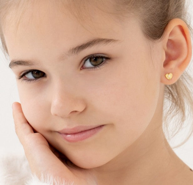 Heart earrings on young girl modeling 14k solid gold sparkling sunray heart stud designs.