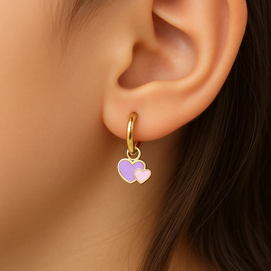 Heart hoop earrings featuring colorful enamel double heart charms on a gold plated hoop.