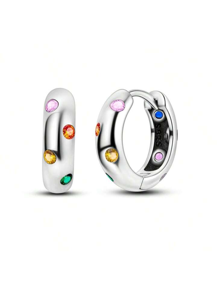 A pair of sterling silver huggie hoop earrings with multicolored cubic zirconia stones designed for children and teens.