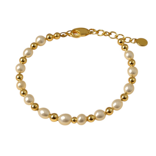 Children’s bracelet with alternating freshwater pearls and shiny gold beads, featuring a gold lobster clasp and heart charm, displayed on a white background