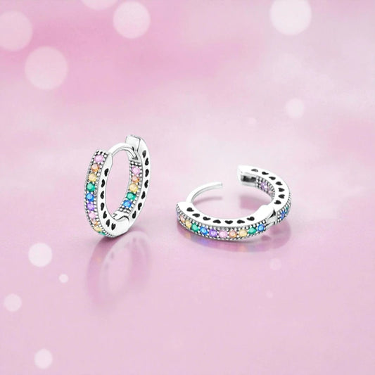 Rainbow CZ hoop earrings featuring shimmering AAA CZ stones in a sterling silver huggie design.