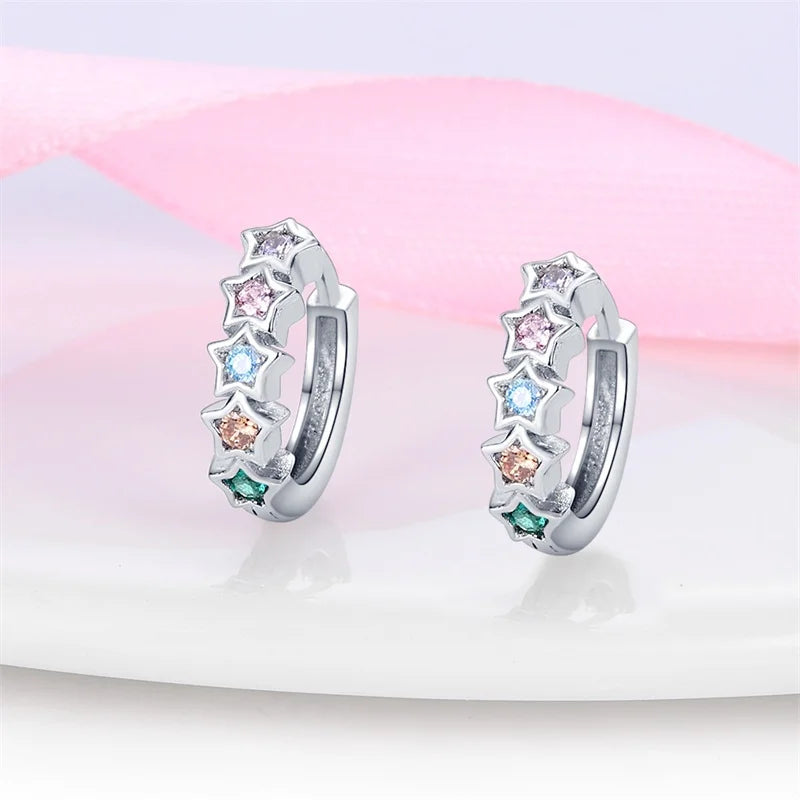 Star hoop earrings made of 925 sterling silver adorned with rainbow cubic zirconia stars, showcasing colorful celestial charm.