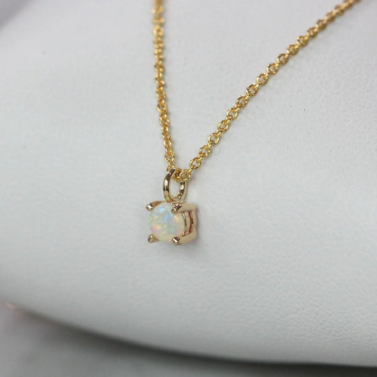 Sterling silver opal necklace featuring a 6mm lab-created opal on a delicate gold-plated chain.