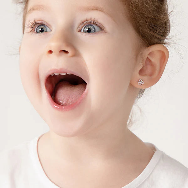 Girl wearing sterling silver flower stud earrings with safety screw backs