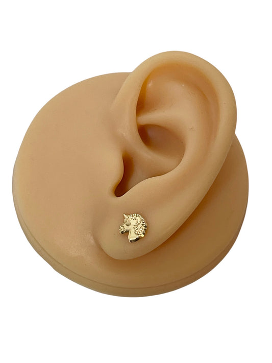 Unicorn earrings displayed on a model ear with 14k solid gold unicorn stud design.