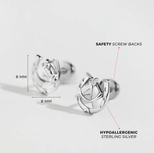 Silver horseshoe stud earrings with safety screw backs on a light grey background