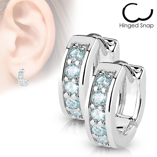 Aqua CZ huggies in surgical steel, featuring brilliant aqua cubic zirconia for children, showcased on an ear.