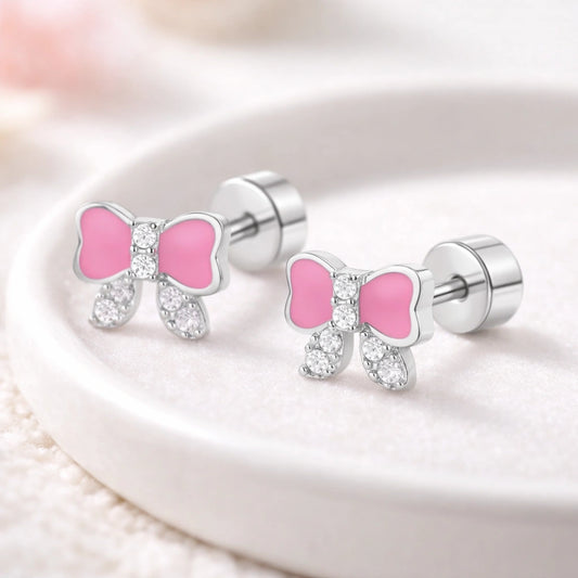 Children's Earrings featuring pink bow design with CZ accents in surgical steel screw-back studs.