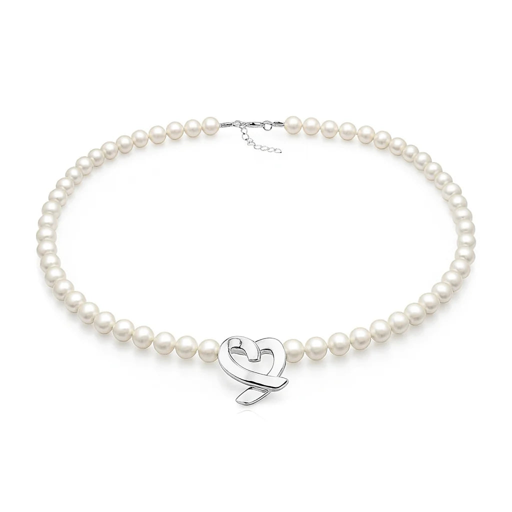 Pearl necklace with a silver heart-shaped clasp on a white background