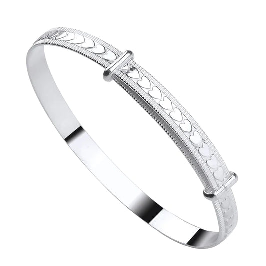 A sterling silver children's bangle with embossed hearts and a bead border, adjustable closure.