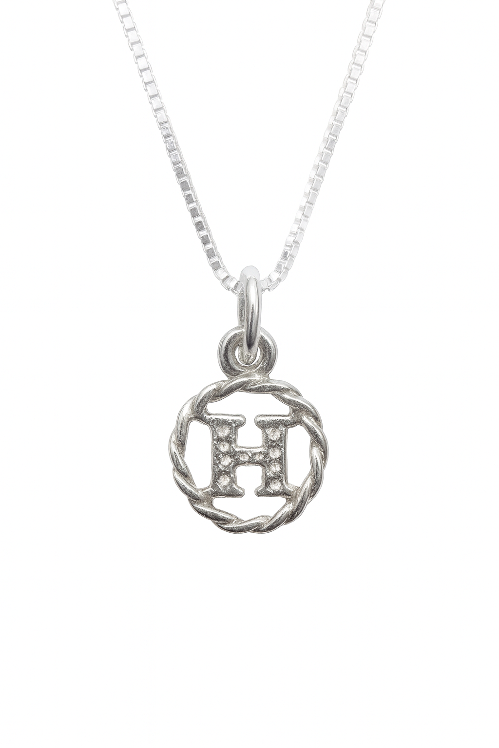 Silver necklace with a circular pendant featuring the letter 'H' on a white background