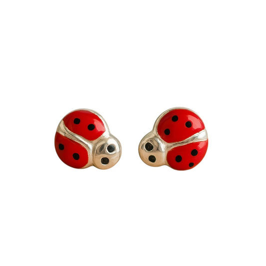 silver ladybug earrings with red and black enamel wings on a white background