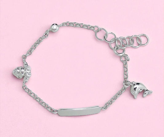 Silver bracelet with charms on a pink background
