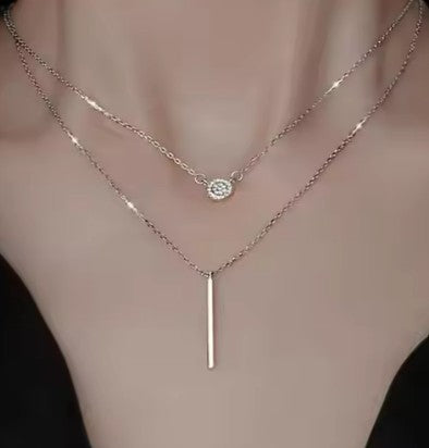 A sterling silver double strand bar necklace with a gift box. The necklace has a contemporary silver bar pendant.