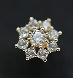 gold plated silver cz snowflake shaped stud earring on dark background