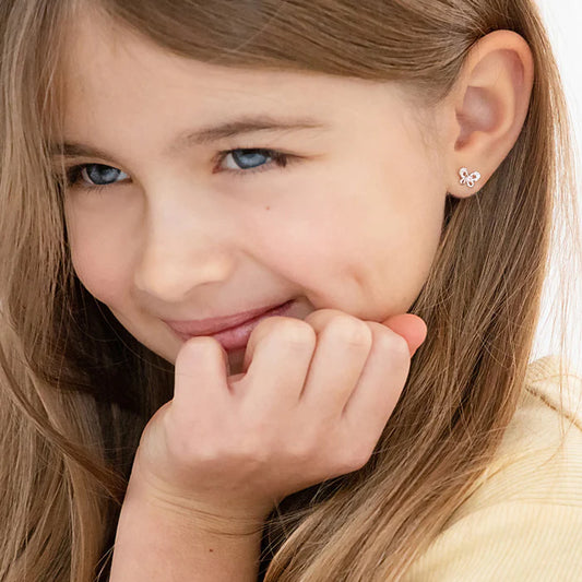 Little girl wearing petite butterfly sterling silver earrings