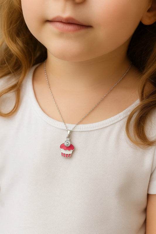Child model showcasing sterling silver cupcake necklace for ages 0-6
