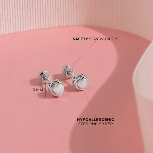 Hypoallergenic sterling silver earrings with safety screw backs on a pink background