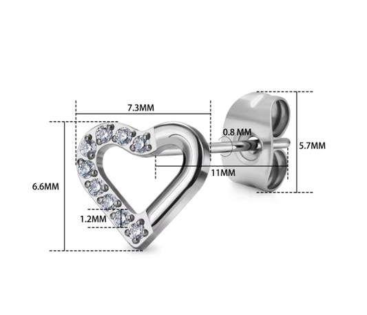 Heart-shaped silver earring with clear gemstones and measurements on a white background