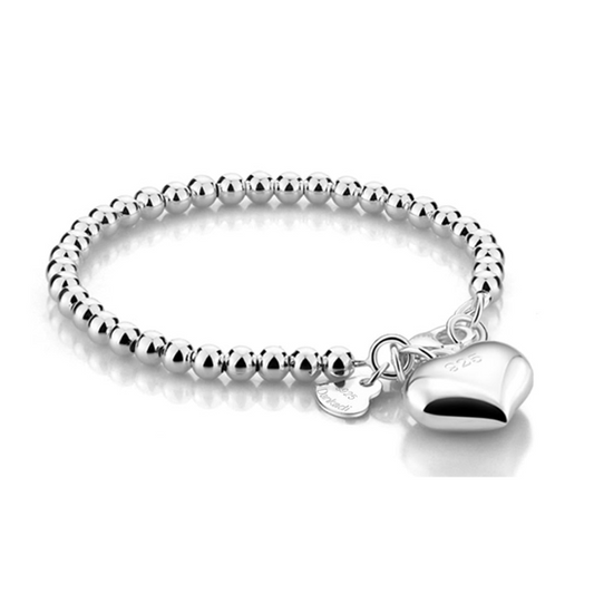 sterling silver hollow ball beaded baby bracelet with highly polished puffed heart charm on a white background
