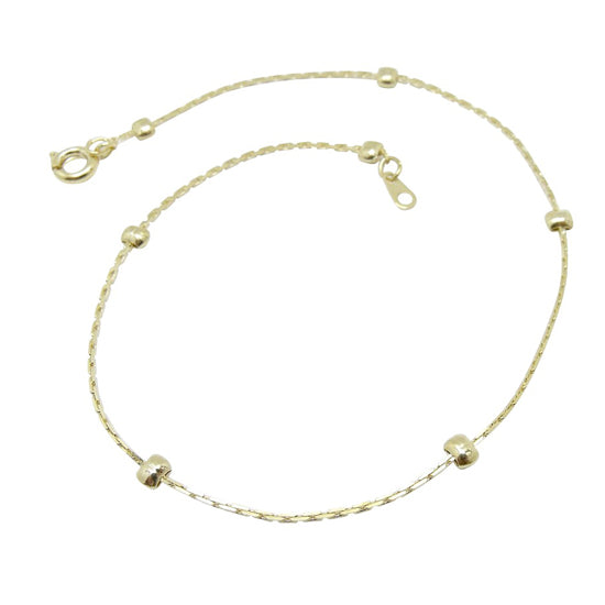 A gold-plated children's anklet featuring tiny gold studs, displayed on a white background.