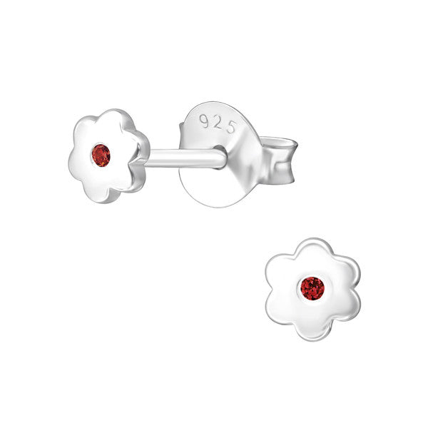 A pair of sterling silver flower earrings with a central garnet CZ, intended for baby girls representing the January birthstone.