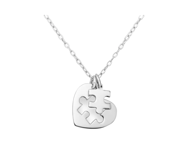 Sleek silver necklace with a heart-shaped pendant containing an interlocking puzzle piece cut-out, accompanied by a removable puzzle piece charm, displayed on a clean white background