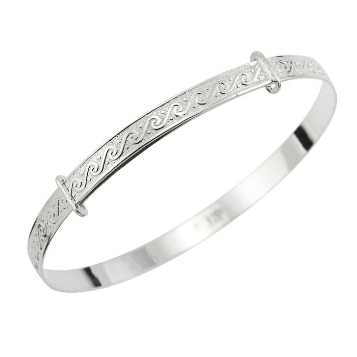 Sterling silver children’s expandable bangle with a continuous wave-pattern engraving along the top and two slider rings for adjustment, shown on a white background.