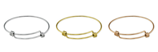 An adjustable gold-coloured surgical steel charm bangle for children.