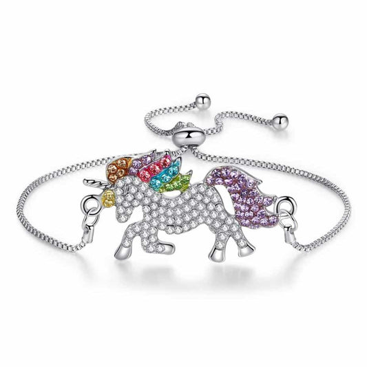 A crystal-encrusted unicorn charm bracelet with rainbow-colored mane and tail, featuring a silver adjustable box chain and slider clasp on a white background.