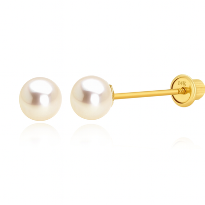 Gold pearl earrings on a white background