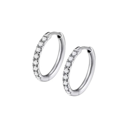 Close‑up of a pair of small silver‑tone hinged hoop earrings, each front half encrusted with a neat row of clear round gemstones and featuring a smooth click‑shut closure.