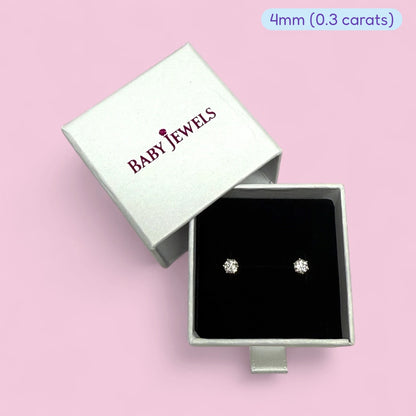 Moissanite earrings in a silver box, featuring 4mm (0.3 carats) genuine moissanite jewels.