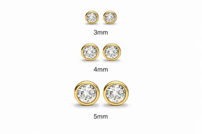 Children's earrings in three sizes: 3mm, 4mm, and 5mm bezel set round cubic zirconia in 14k solid gold.