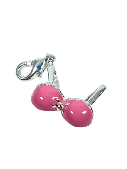 A silver-plated, pink enamelled bikini top charm with a clip for jewelry making.