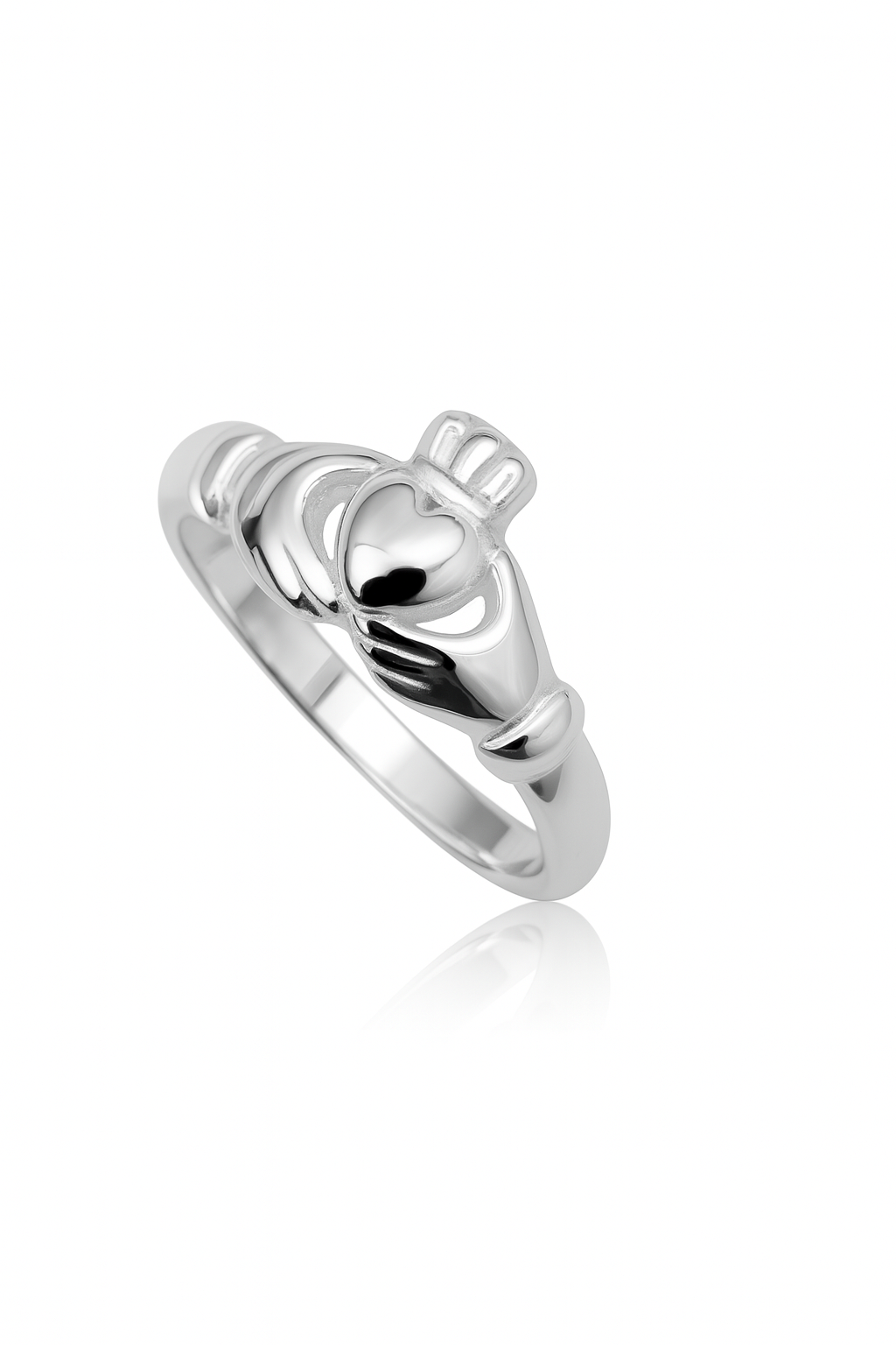 Close-up of a sterling silver Claddagh ring on a white background with a subtle reflection; the design features two hands holding a heart topped by a crown.
