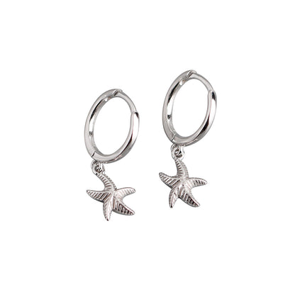 A pair of sterling silver hoop earrings with dangling starfish charms.