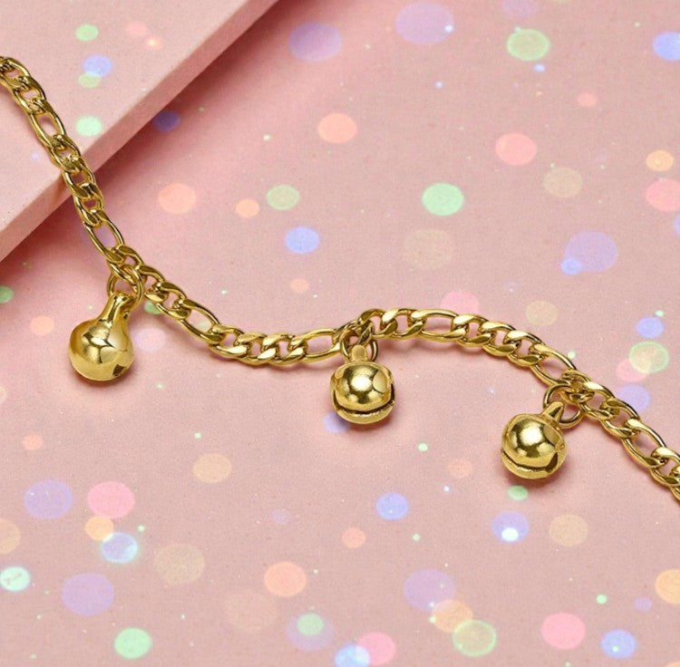 Children's anklets featuring playful gold musical bell charms on a colorful background.